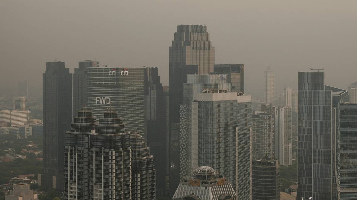 A polluted site with workers in hazmat suits cleaning up contaminants.